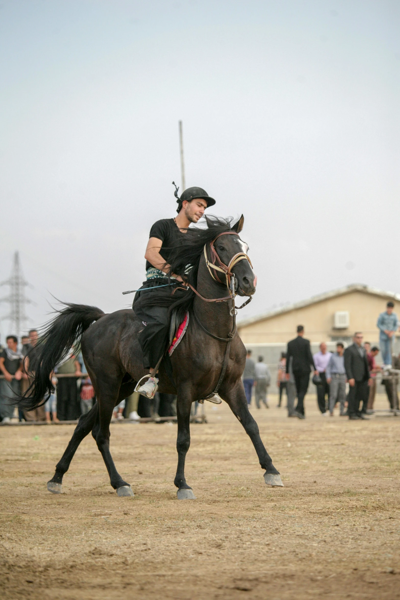 the person is riding a horse with people watching from the stands