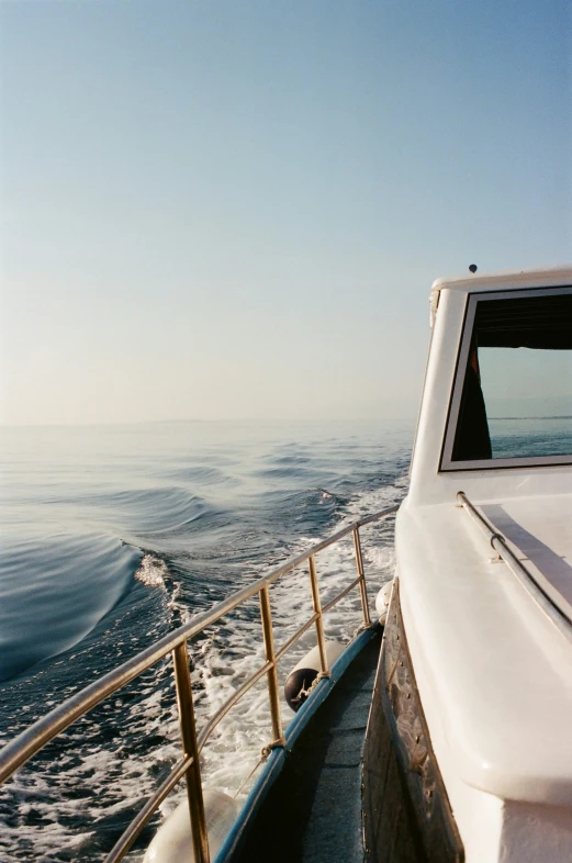 some water and a person on a boat going up to the shore