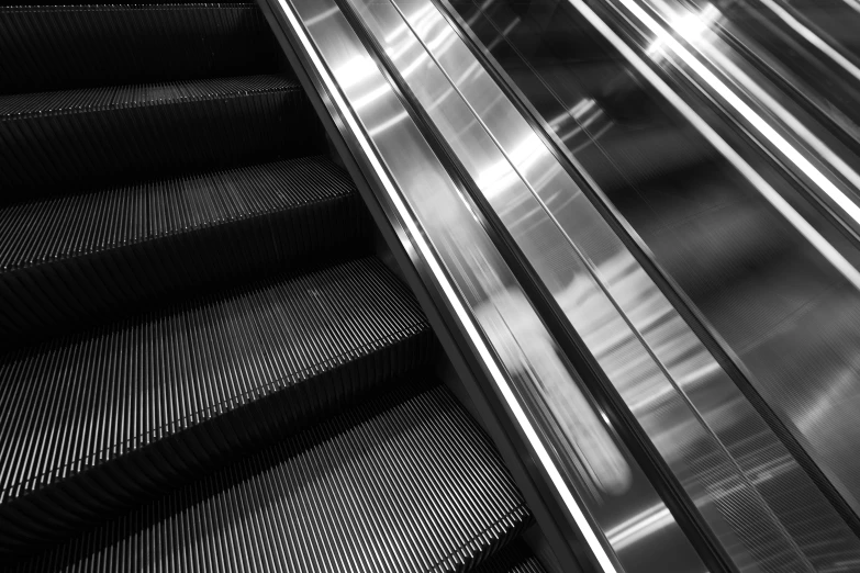 a close up of an escalator near some people