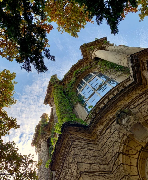 looking up at a tower with a clock and a sky background