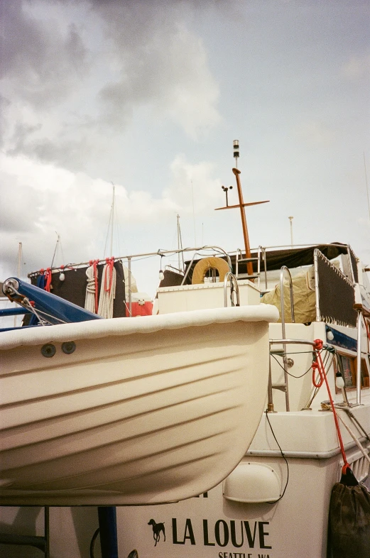 a group of sailboats sitting in front of one another on the beach