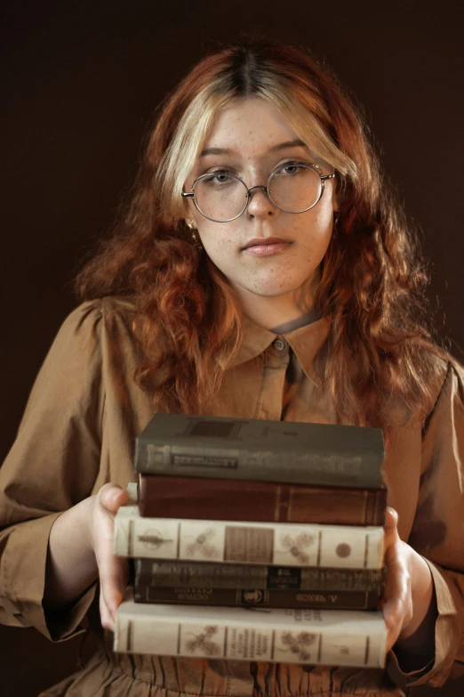 a woman holding books, which look like they have no glasses