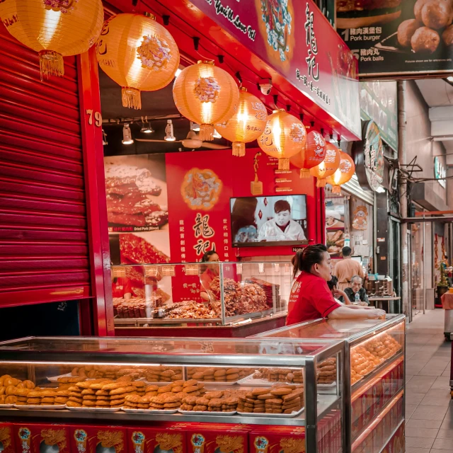 woman in red sweater sitting at food stand