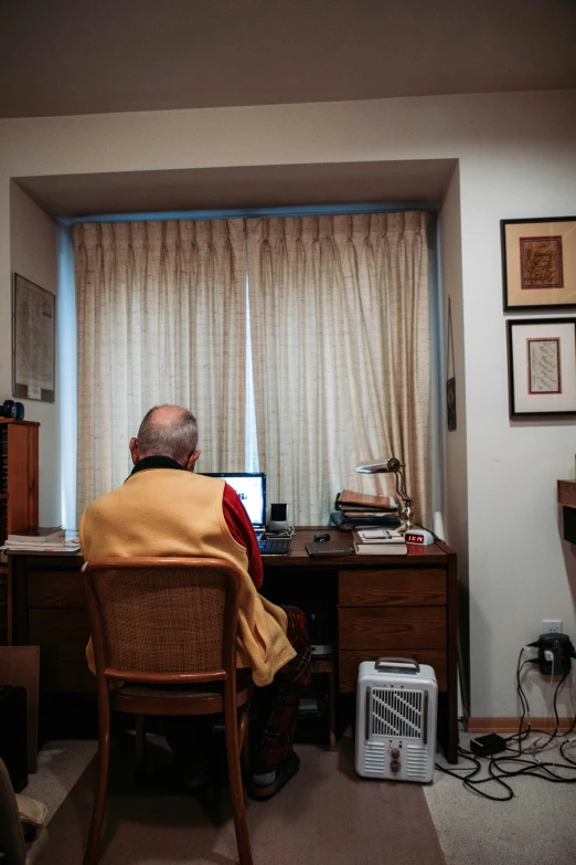 man using a computer at his home office