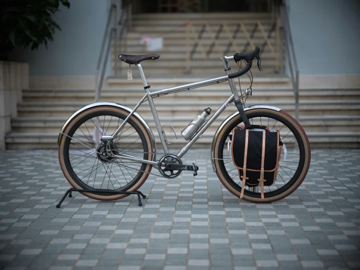 a bicycle with wooden seat on top of a sidewalk