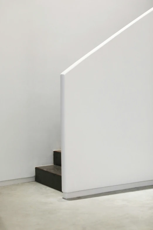a white wall with steps and a light