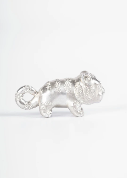 silver plated metal tiger figurine on a white background