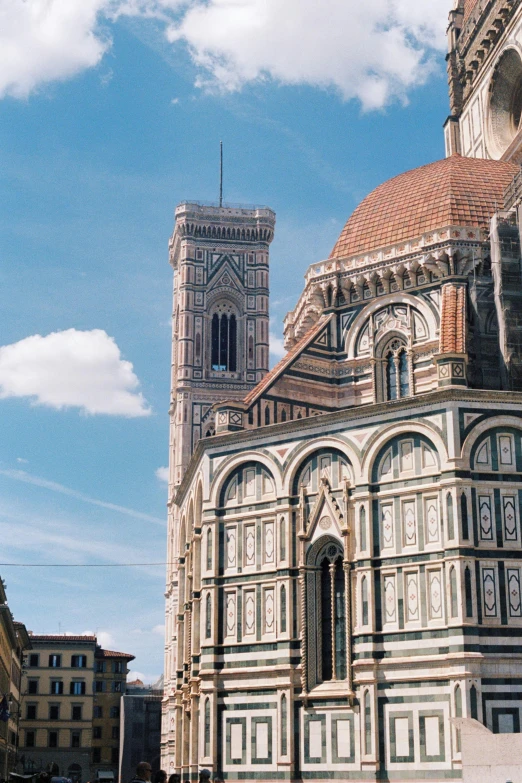 a very tall and ornate church with a sky background