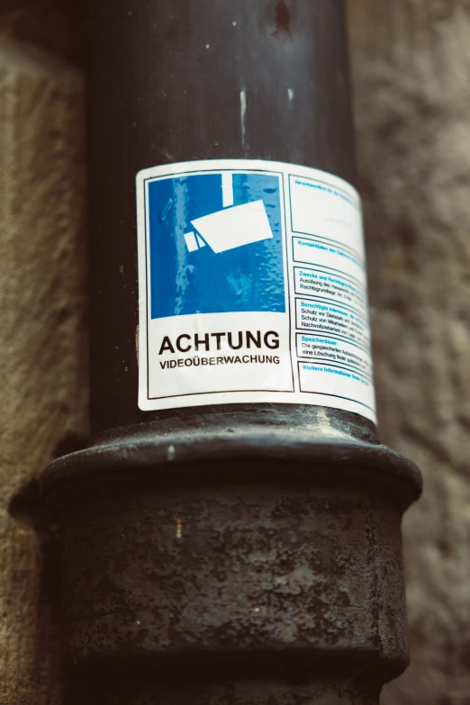 a close up image of an actung sign on a pole
