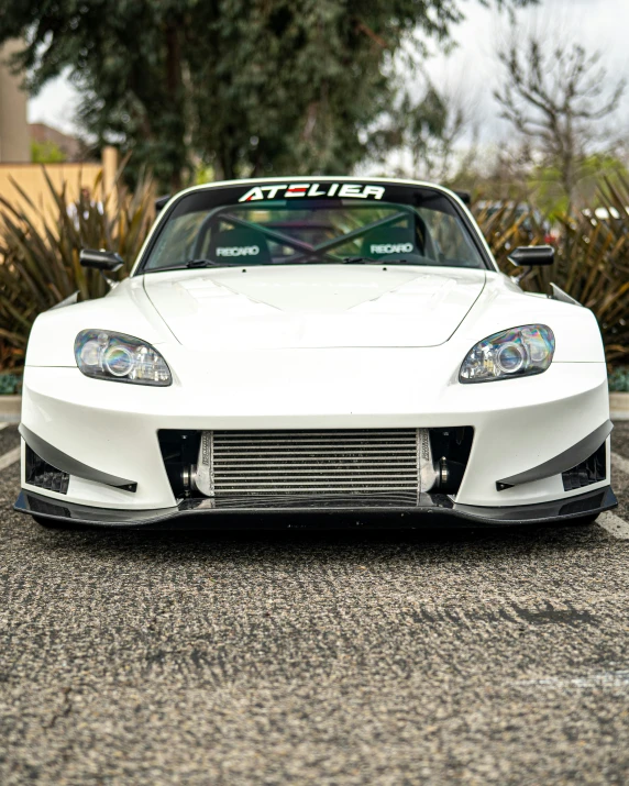 white sports car parked in the parking lot