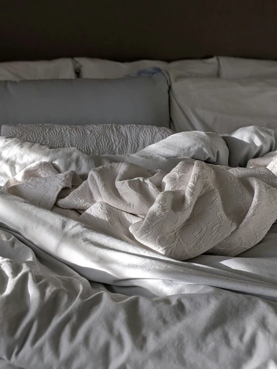 a bed with sheets in it is shown