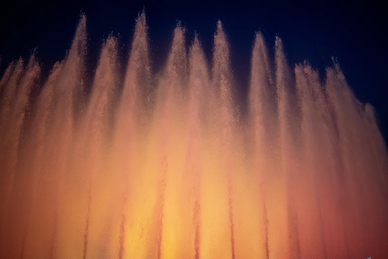 a colorful fountain with several jets in the sky