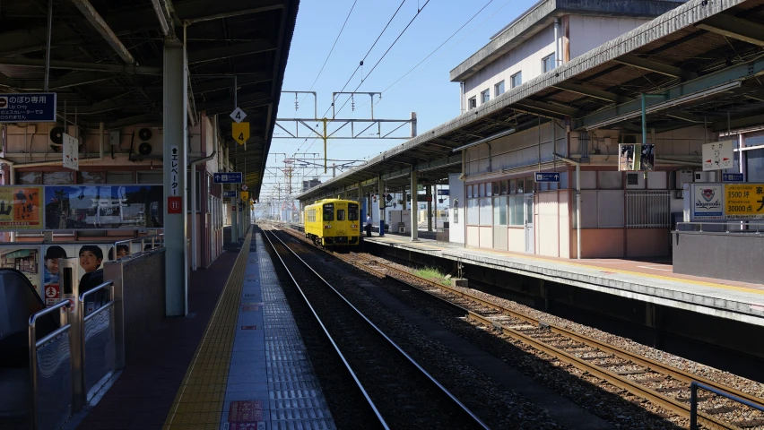 a train station with a train on a track next to a platform