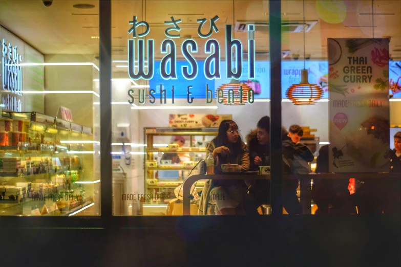 three people sitting in front of a store