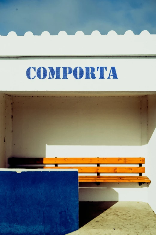 a blue bench in front of a white building