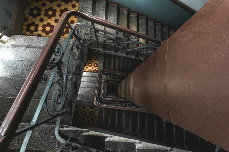 a group of brown stairs leading up to a ceiling