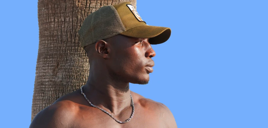 the man is wearing his tan hat with a chain