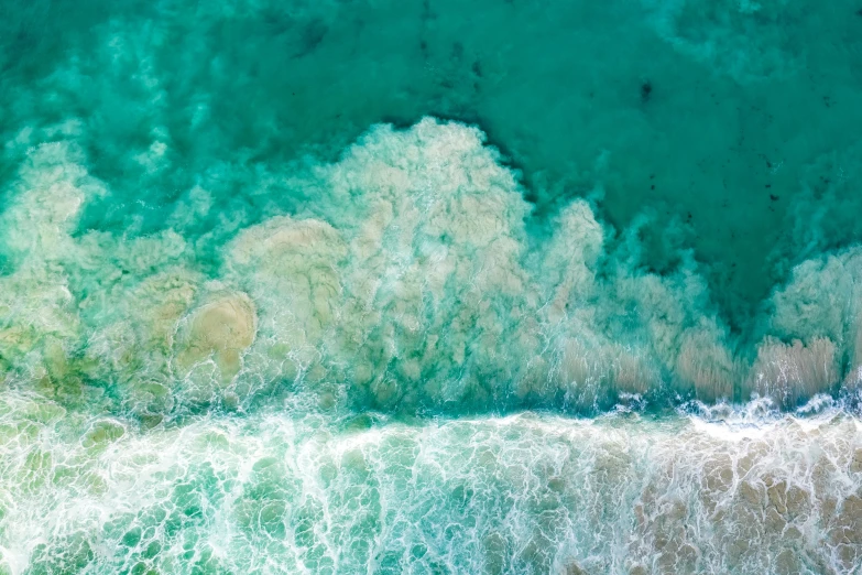 top view of the ocean showing the foamy waves