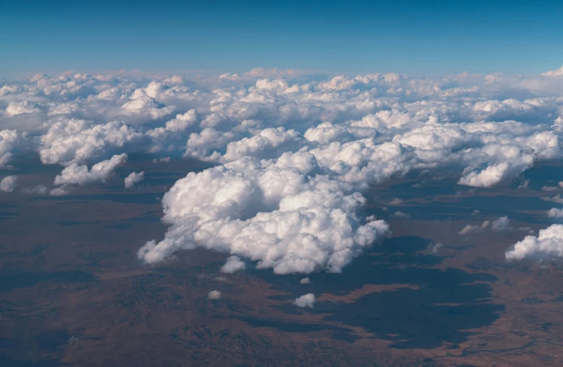 the view from an airplane looking over some clouds