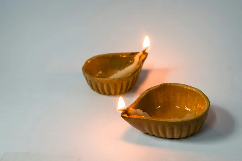 two candle holders with one on the left and the other on the right