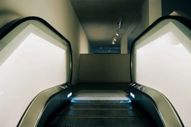 view from the bottom up a escalator at an airport