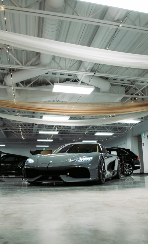 a car parked in a garage near two other vehicles