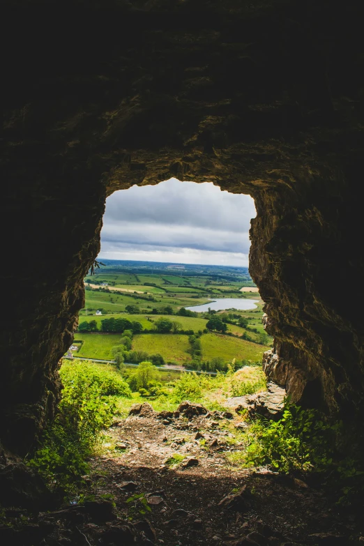 a view out of an old stone window on the countryside