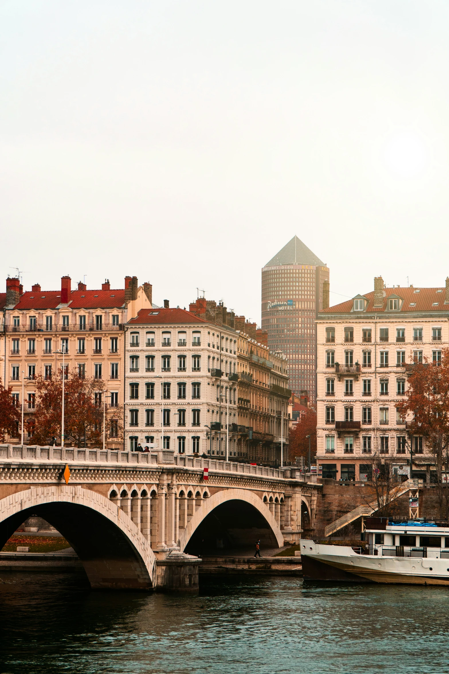 boats are traveling along the water in a city