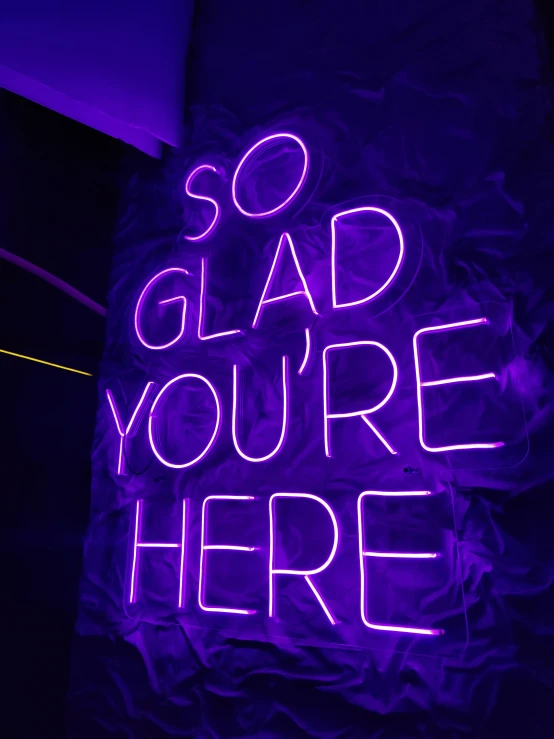 a neon sign with some words on it