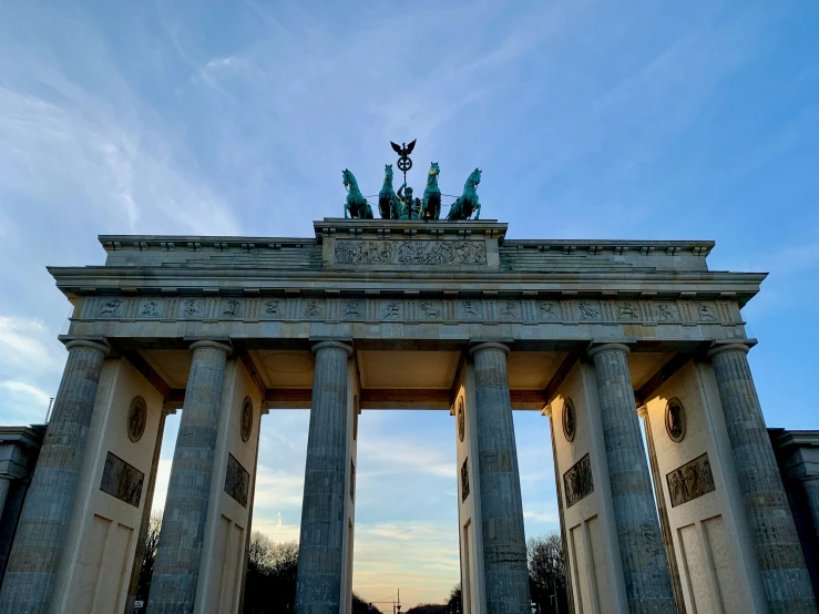 a large gate with three statues on it