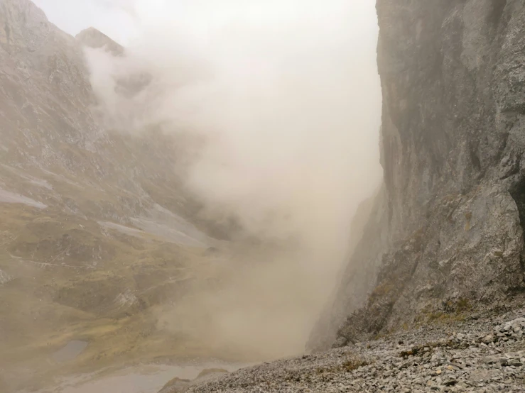 there is a hiker on a hill above the fog