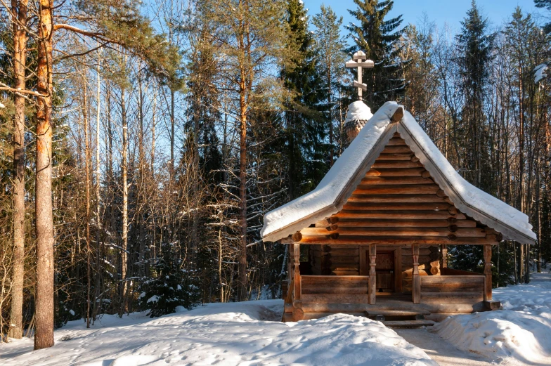 an old log cabin nestled in the snow