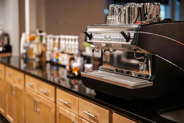 a line of espresso machine sitting on a counter