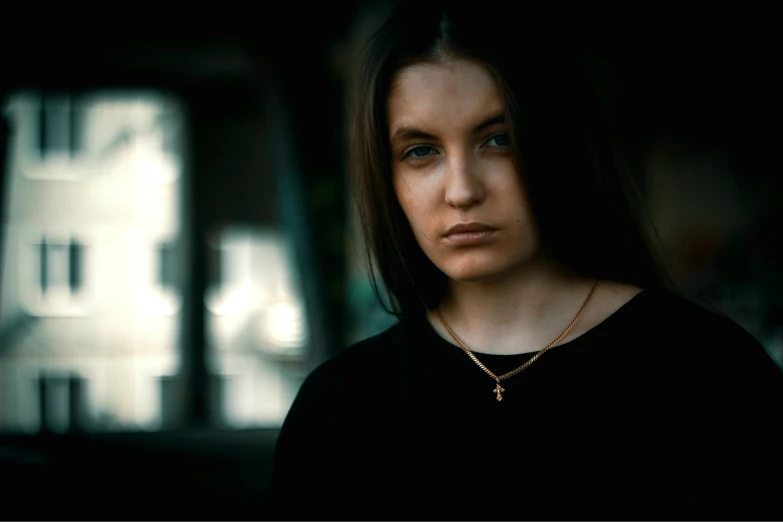 a woman in a black top standing by herself