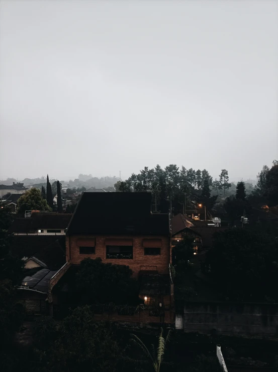 an aerial view of a small building and trees