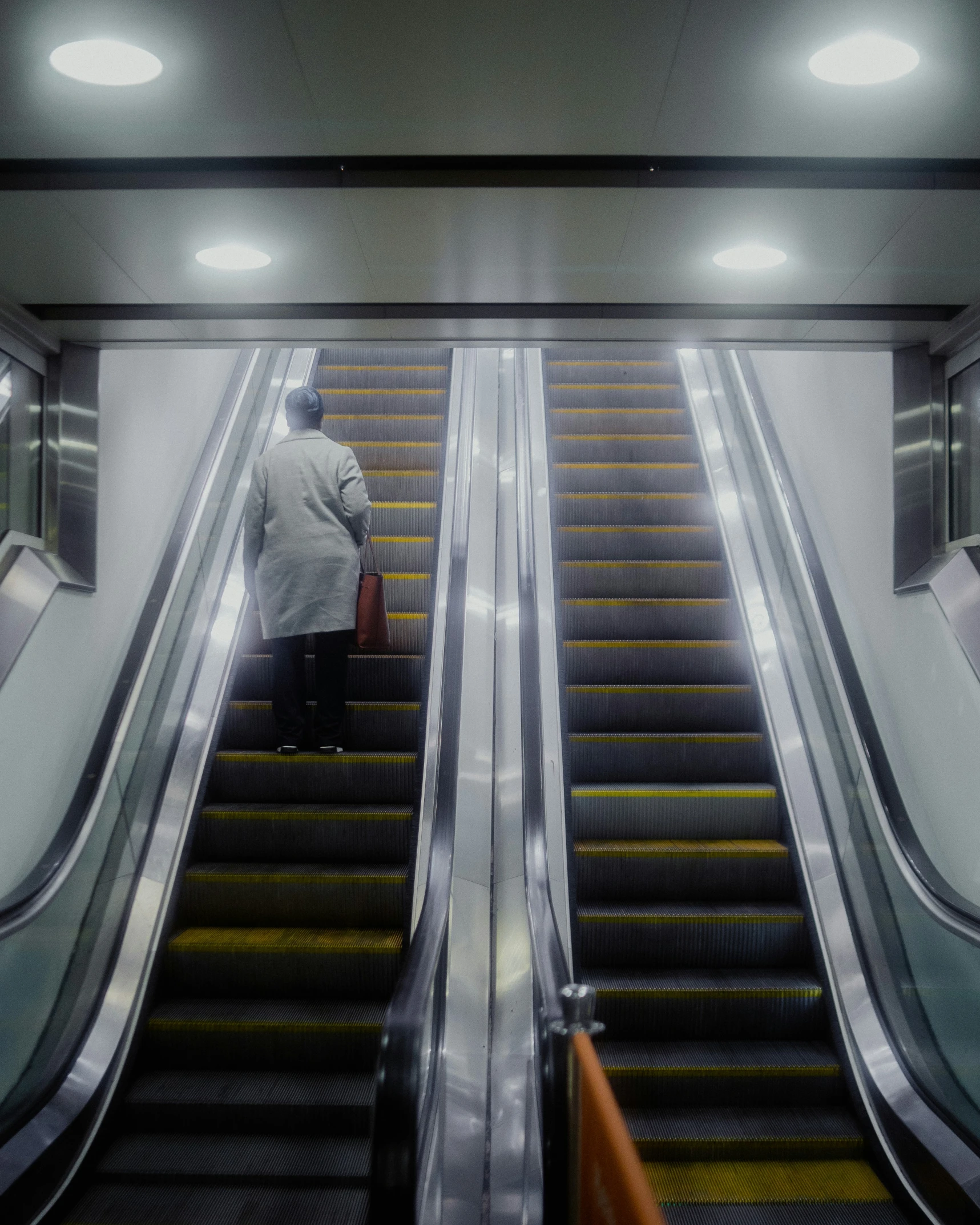 two people on an escalator in a subway