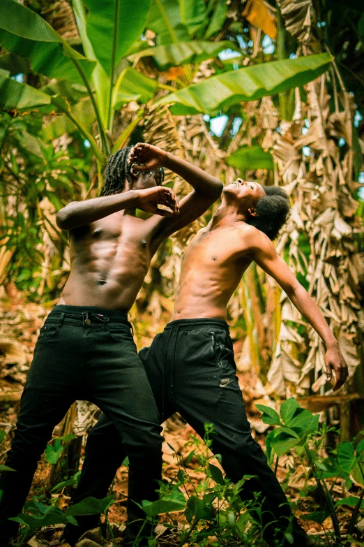 two men in the forest with a camera in hand