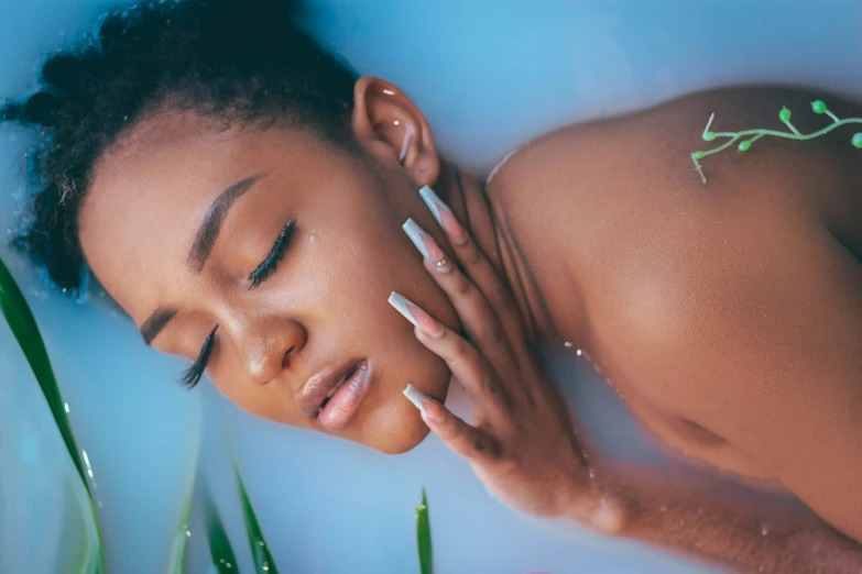 a  lady relaxing in a bathtub with soap and white candles