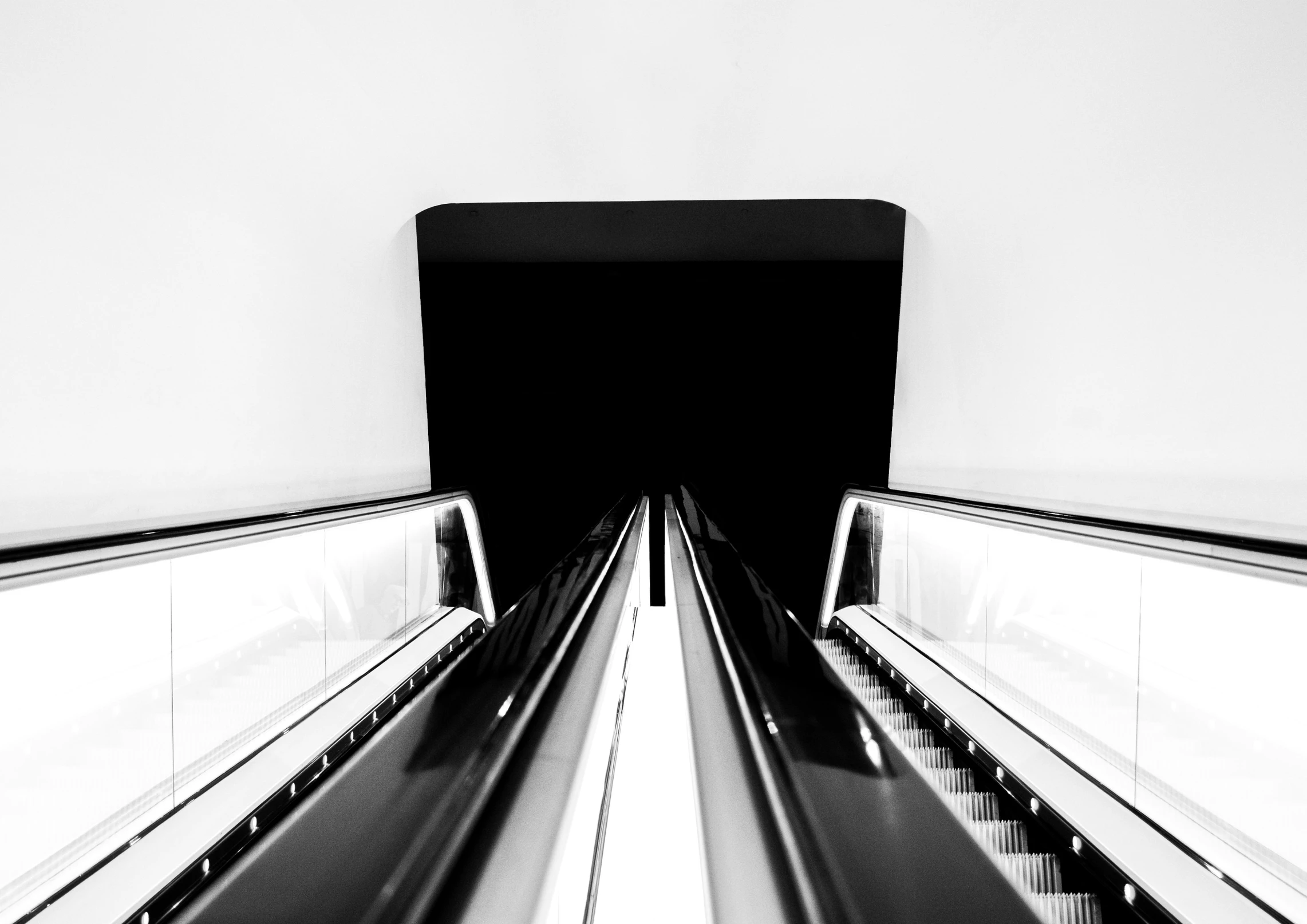 an escalator going down a hill towards the sky