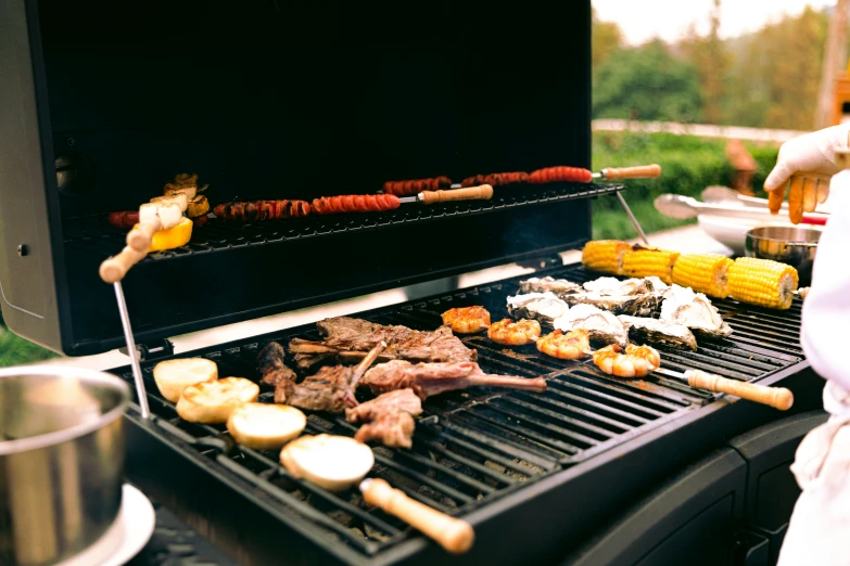 a close - up of an outdoor grill with food cooking on it