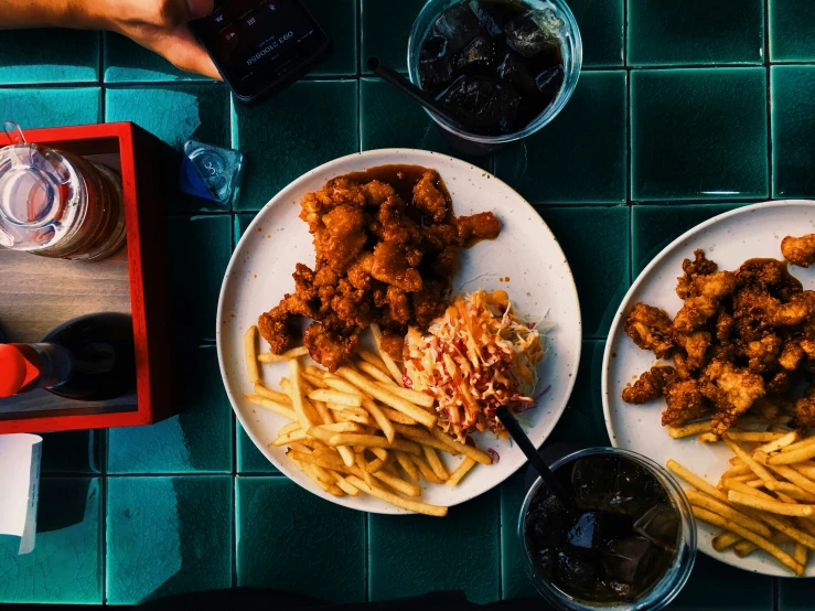 a table topped with plates of food and drinks