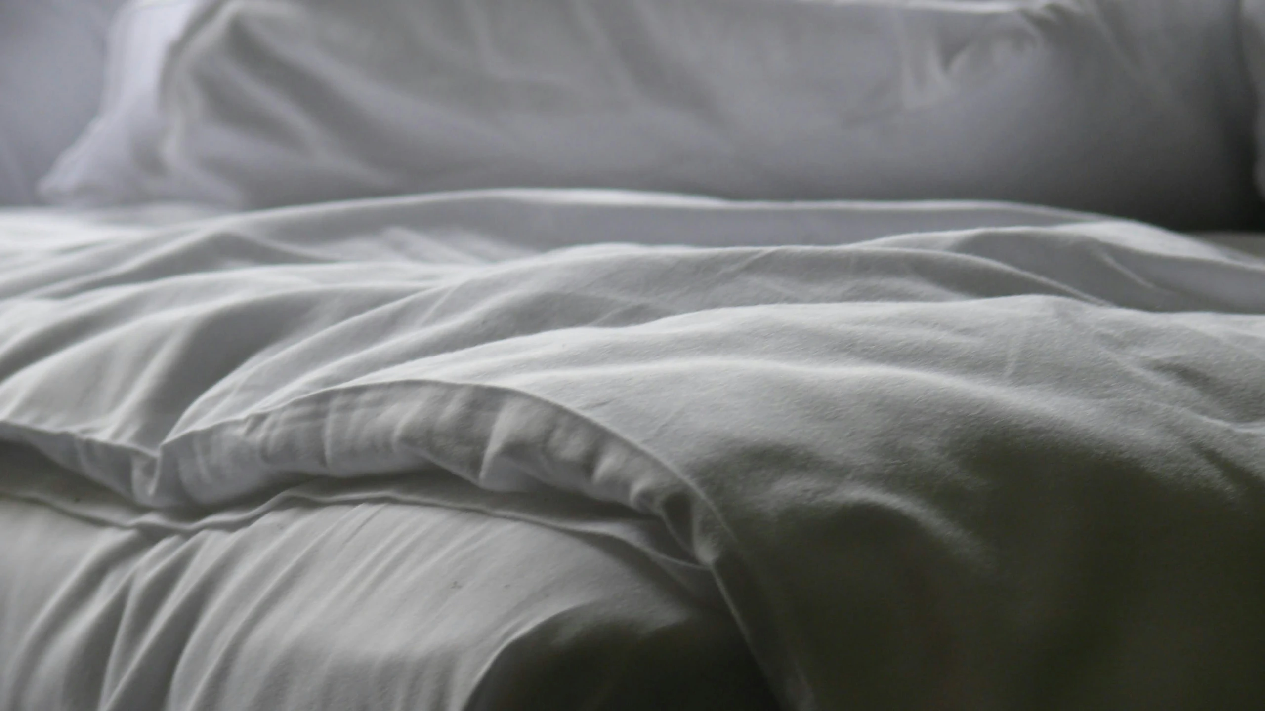 a close up of a blanket with white sheets