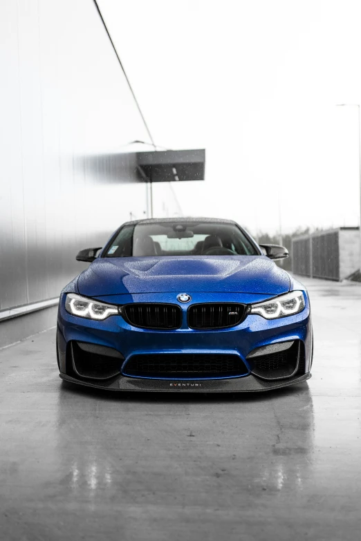 a bmw blue car parked in the dark