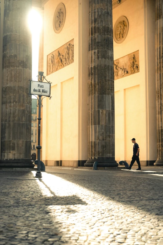 a man walks by an empty street light