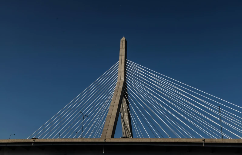 a very tall bridge with the sky in the background