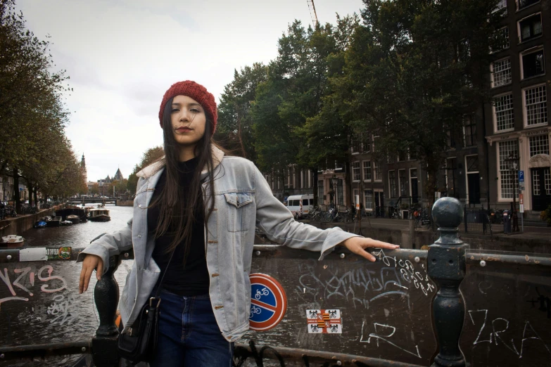 woman with long hair leaning against a wall