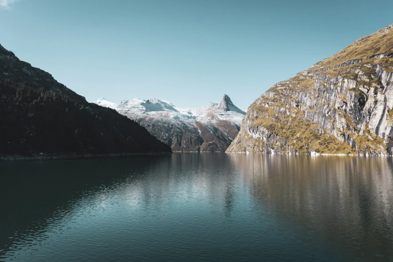 a large body of water with mountains in the background