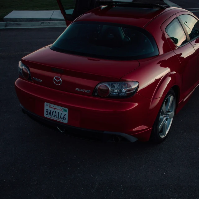 a red car parked in front of another car