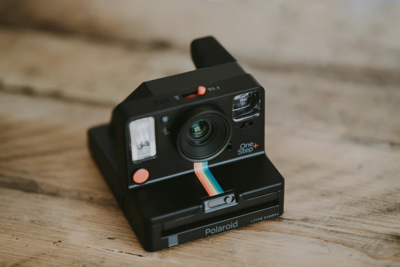 an old polaroid camera sits on a table