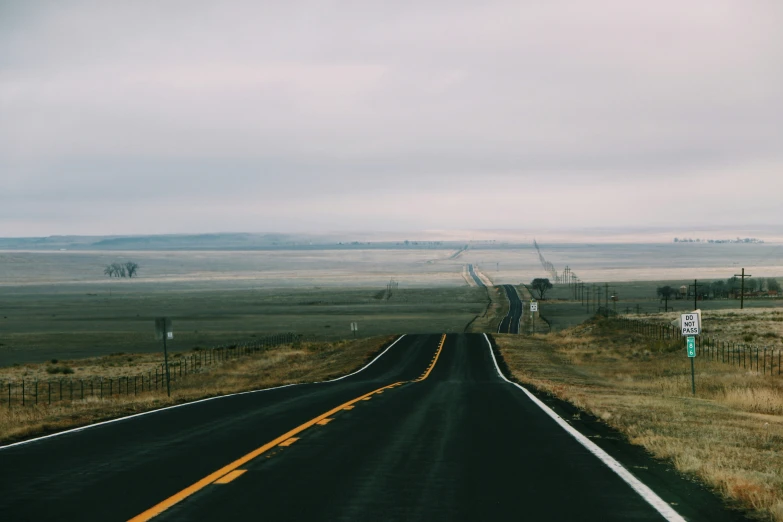 a long country road in the middle of the plains